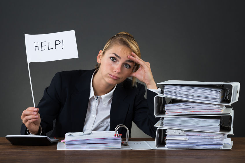 Businesswoman Holding Help Flag While Looking At Folders